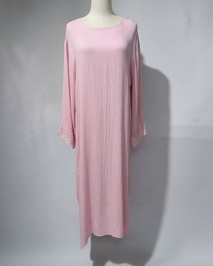 Awra.at pink abaya made from 85% viscose and 15% polyester with lace trim on the sleeves.